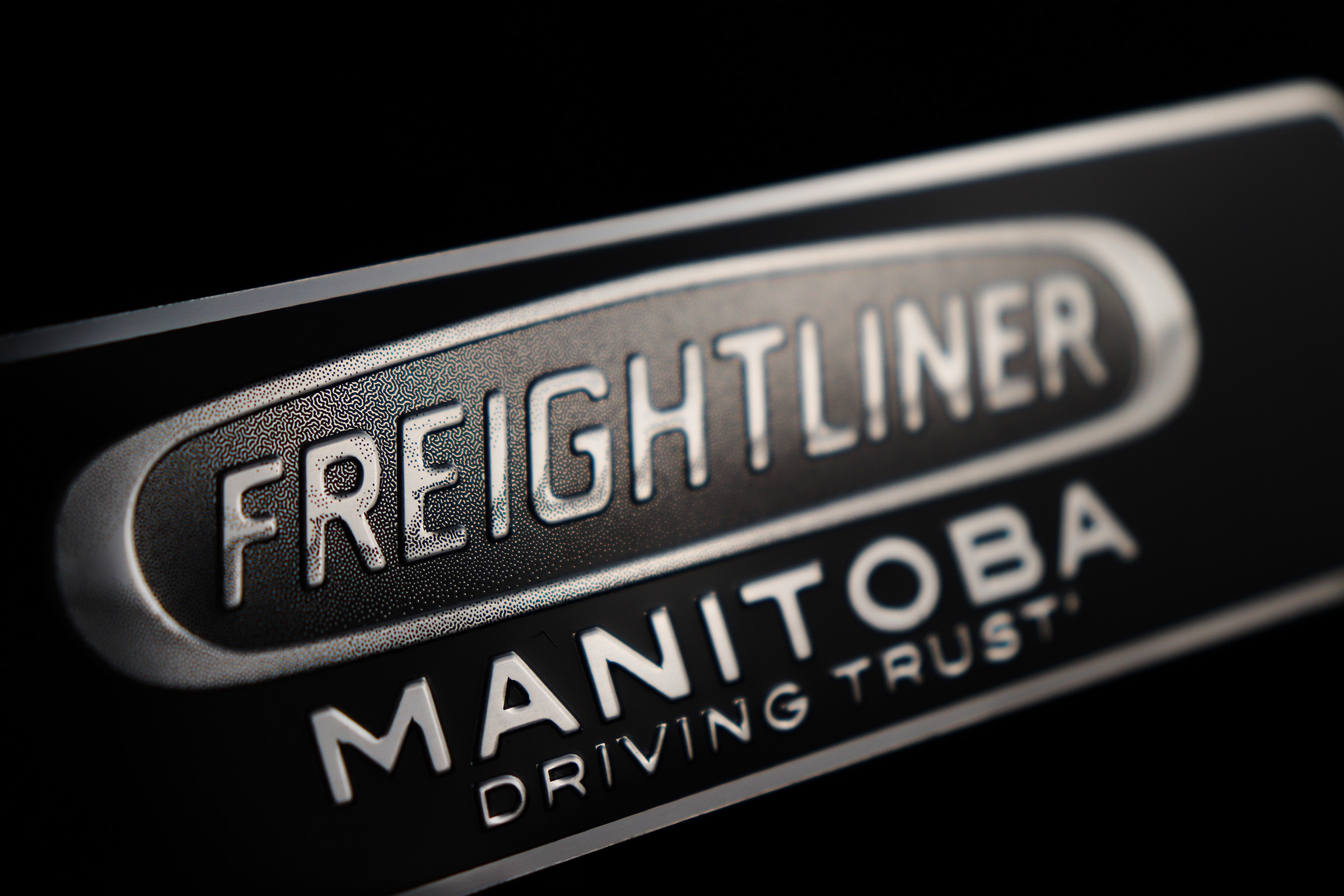 Black and Silver Nameplate with a Technical Pattern