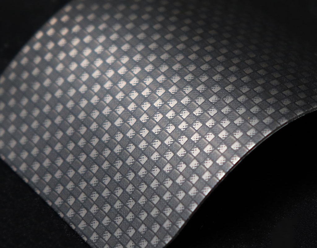 Carbon fiber weave pattern on aluminum surface